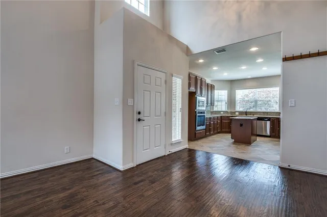 a view of a kitchen with wooden floor and windows