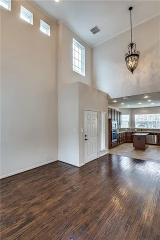 a view of a room with wooden floor and windows