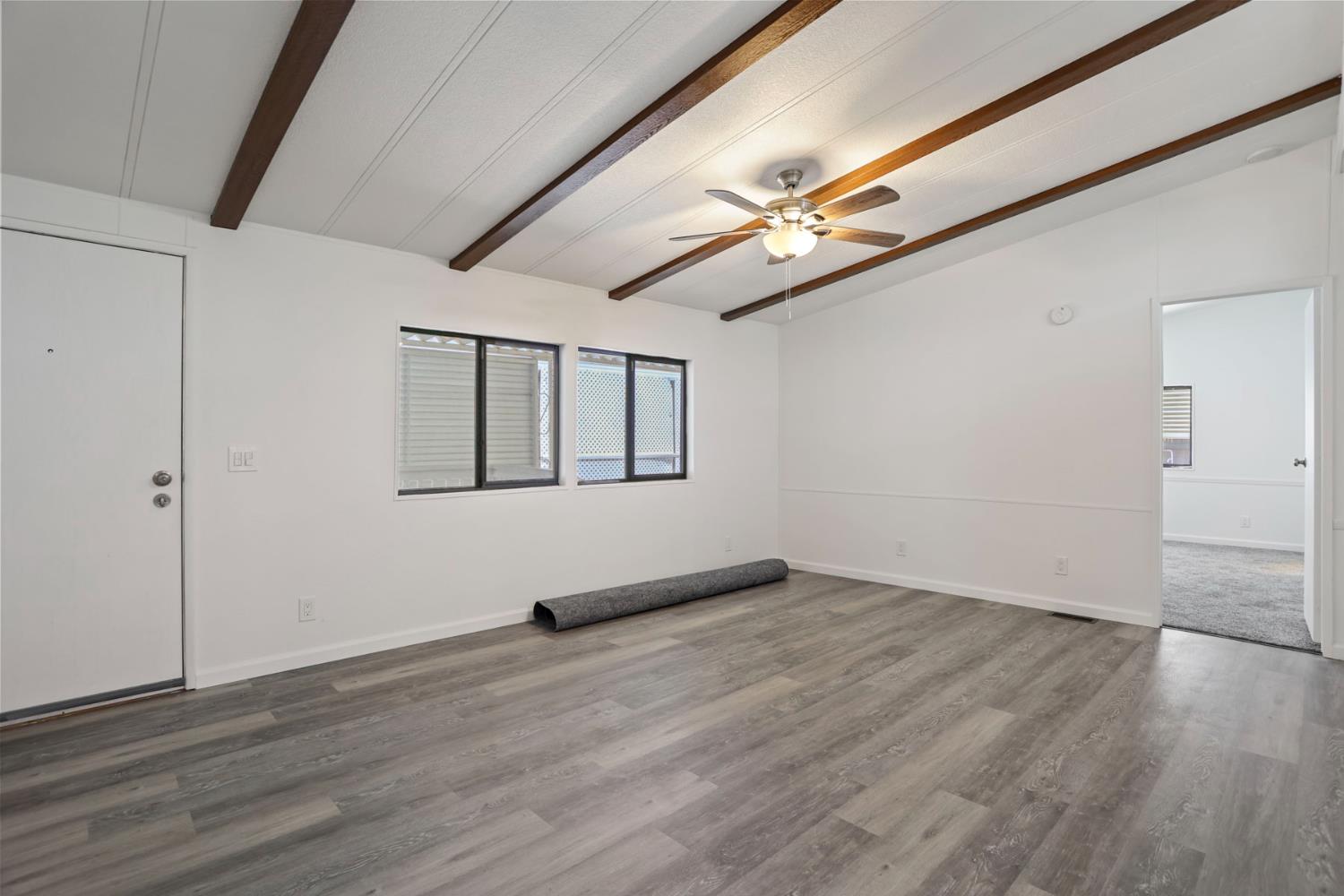 2124 Key W Lane Modesto, CA 95350 - Photo 13 of 30 a view of an empty room with wooden floor and a window