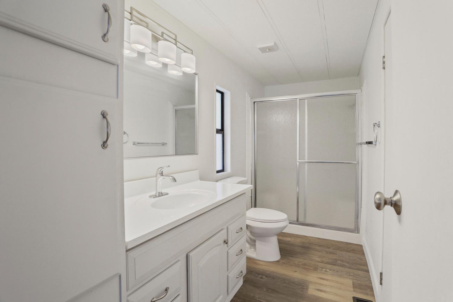 2124 Key W Lane Modesto, CA 95350 - Photo 20 of 30 a bathroom with a sink a toilet a tub and shower