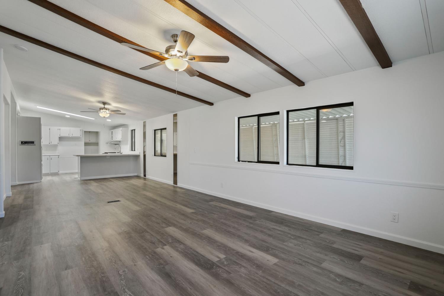 2124 Key W Lane Modesto, CA 95350 - Photo 3 of 30 a view of an empty room with wooden floor and a ceiling fan