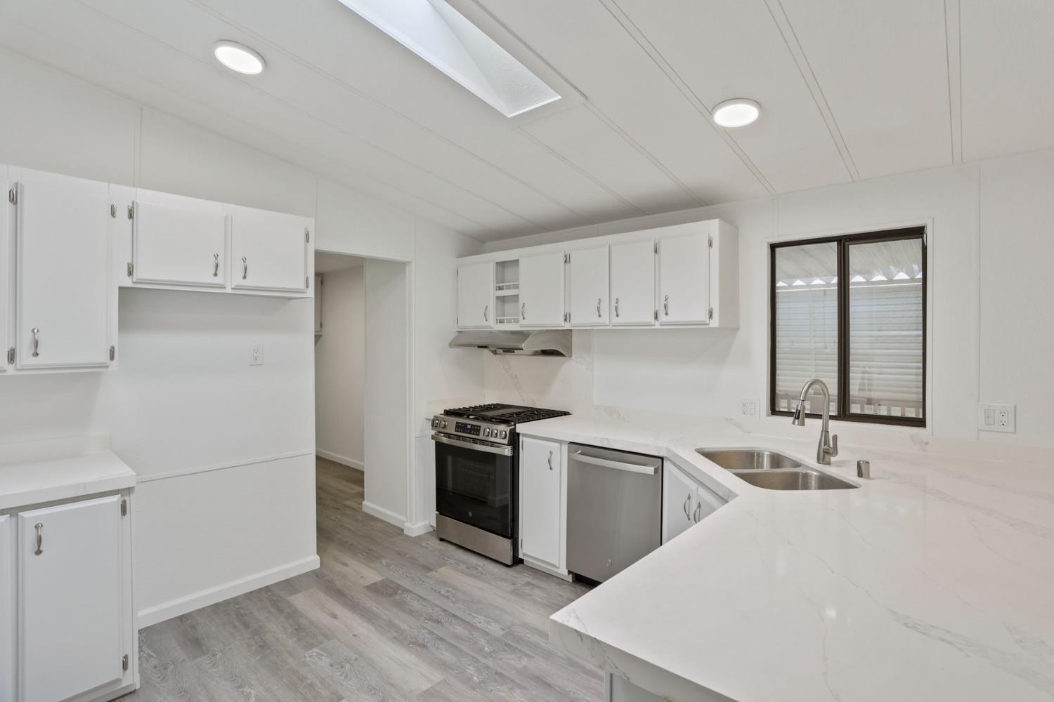 2124 Key W Lane Modesto, CA 95350 - Photo 5 of 30 a kitchen with a sink a stove and refrigerator