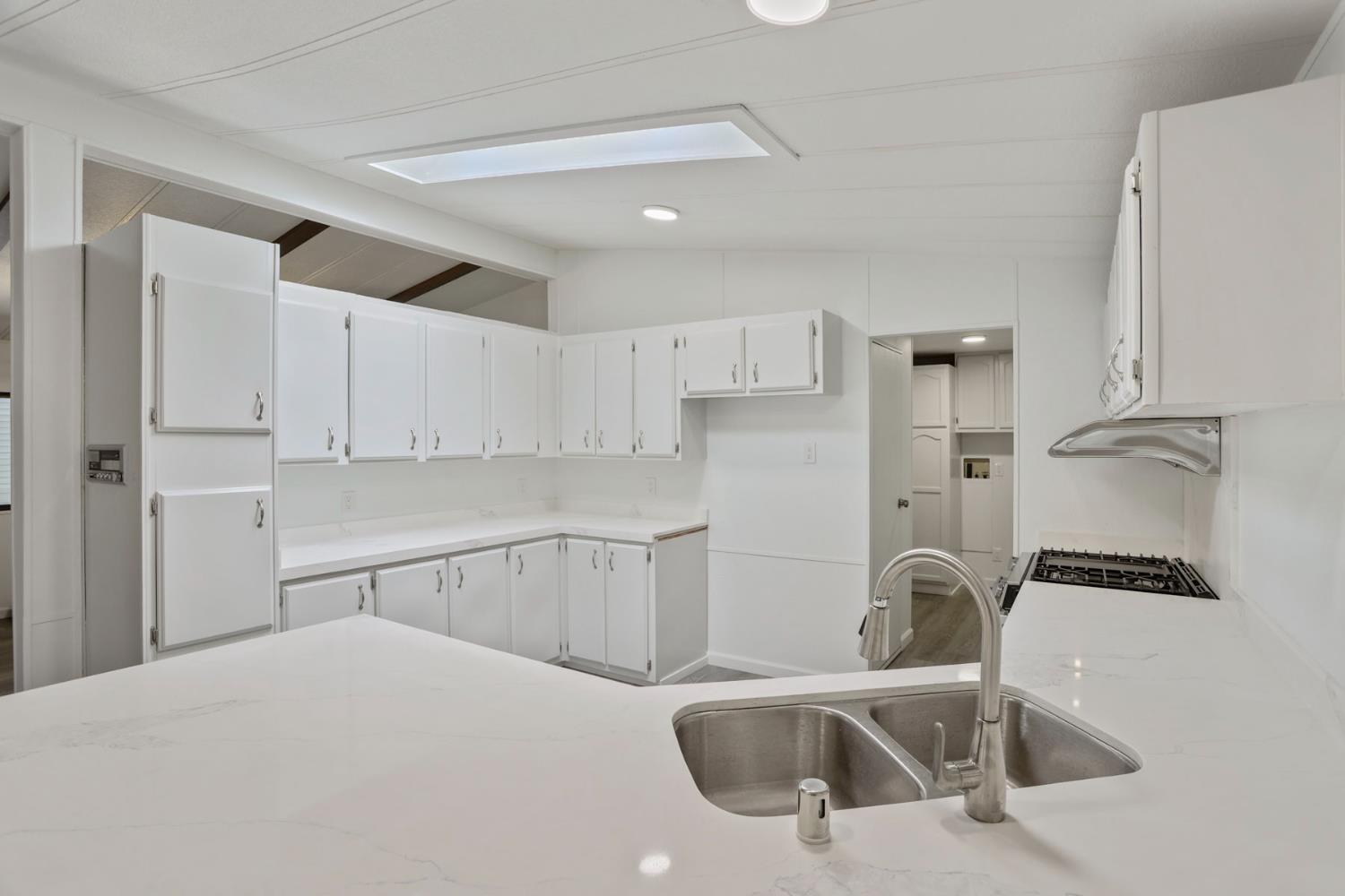 2124 Key W Lane Modesto, CA 95350 - Photo 6 of 30 a kitchen with a sink a refrigerator and cabinets