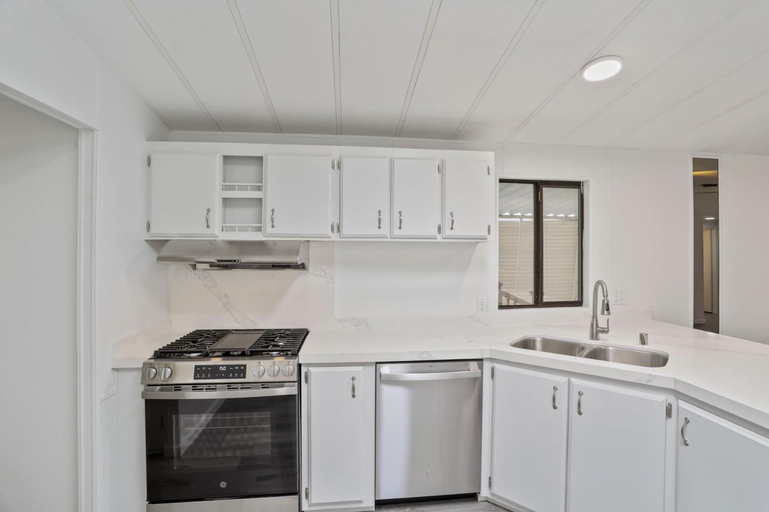 2124 Key W Lane Modesto, CA 95350 - Photo 7 of 30 a kitchen with white cabinets and white appliances