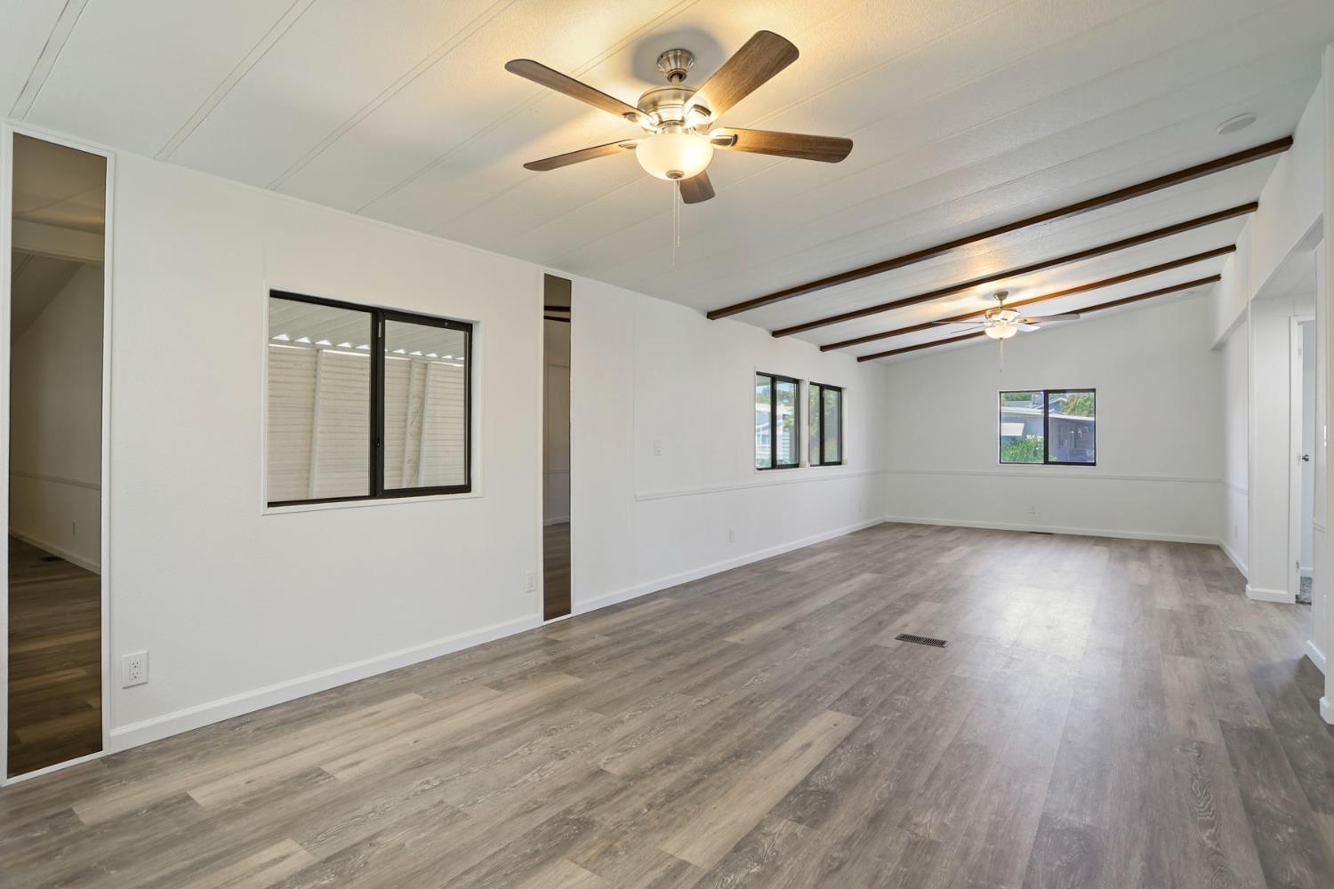 2124 Key W Lane Modesto, CA 95350 - Photo 10 of 30 a view of an empty room with wooden floor and a window