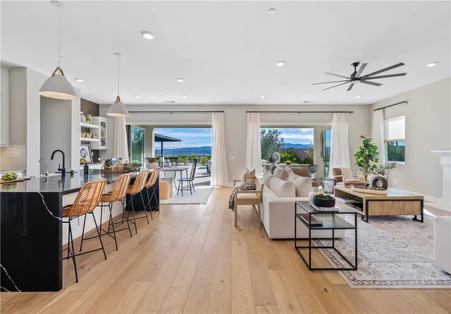 a kitchen with lots of counter top space a stove a dining table and chairs
