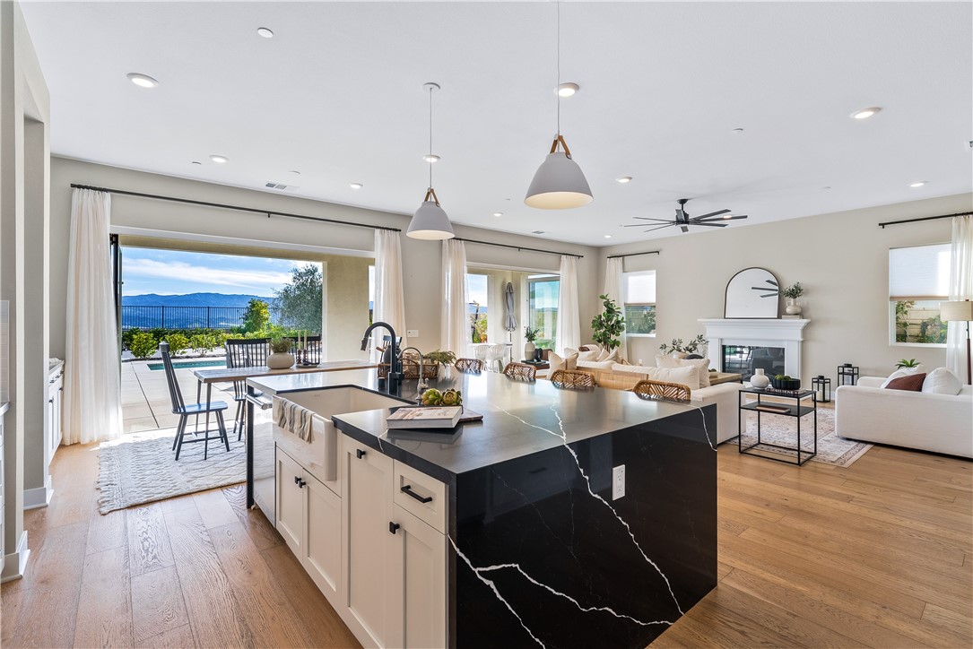 28414 Old Spgs Road Castaic, CA 91384 - Photo 13 of 62 a open kitchen with stainless steel appliances granite countertop a stove a sink dishwasher and a dining table with wooden floor