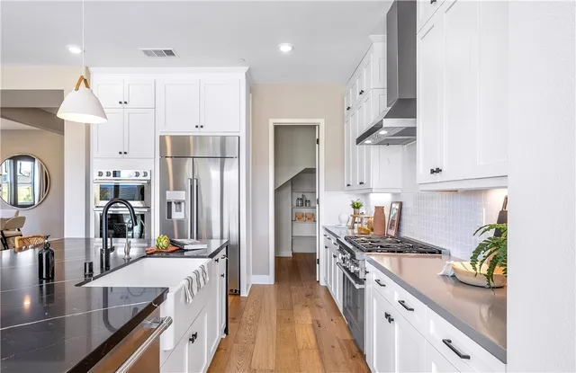 a bathroom with a granite countertop sink and a toilet