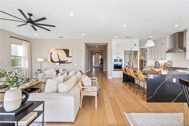 a bathroom with a granite countertop sink toilet and mirror