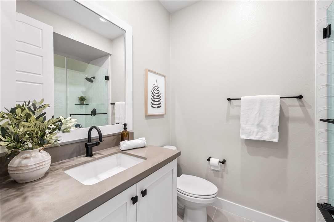 28414 Old Spgs Road Castaic, CA 91384 - Photo 22 of 62 a bathroom with a granite countertop sink and a toilet