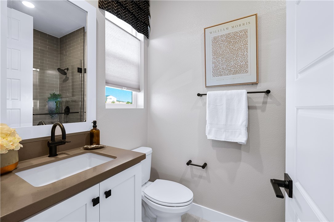 28414 Old Spgs Road Castaic, CA 91384 - Photo 29 of 62 a bathroom with a granite countertop sink toilet and mirror