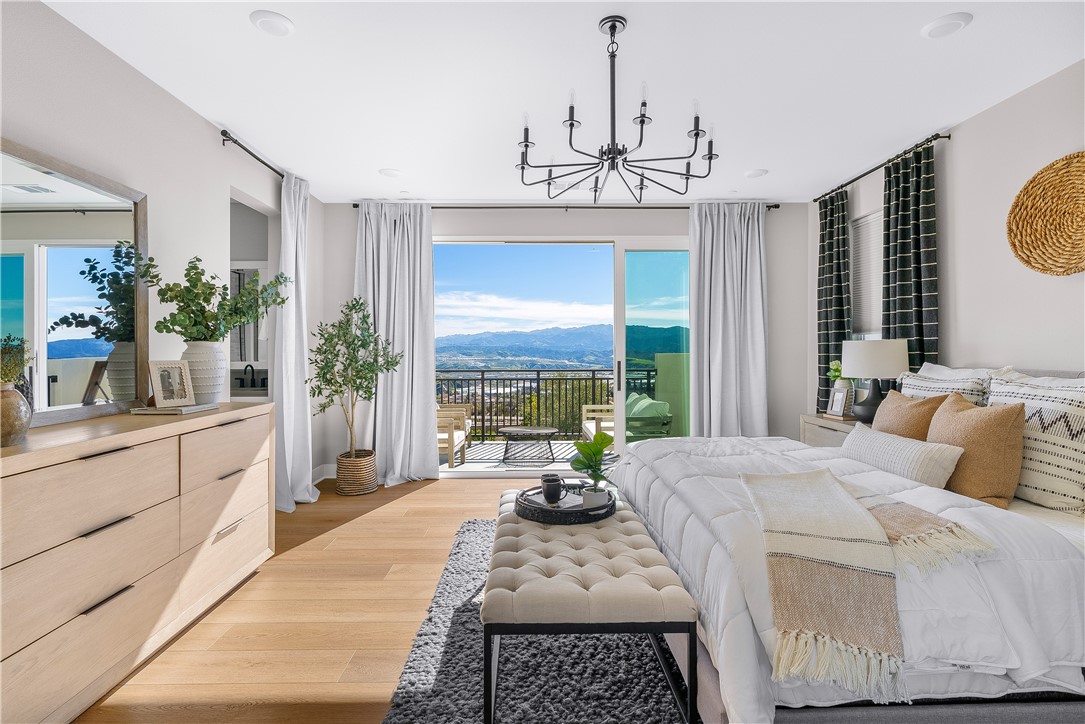 28414 Old Spgs Road Castaic, CA 91384 - Photo 33 of 62 a bedroom with a bed a chandelier and a flat tv screen