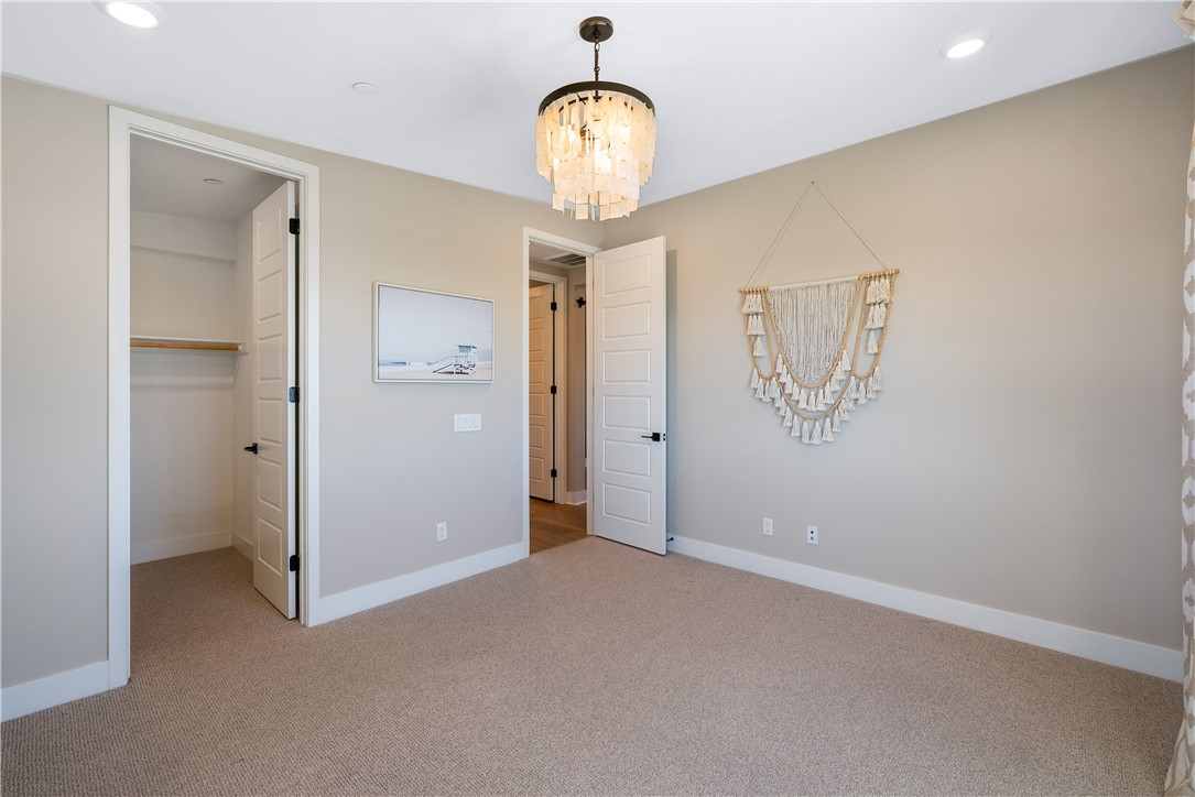 28414 Old Spgs Road Castaic, CA 91384 - Photo 46 of 62 a view of a hallway with a chandelier fan