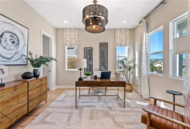 a dining room with furniture potted plants and wooden floor