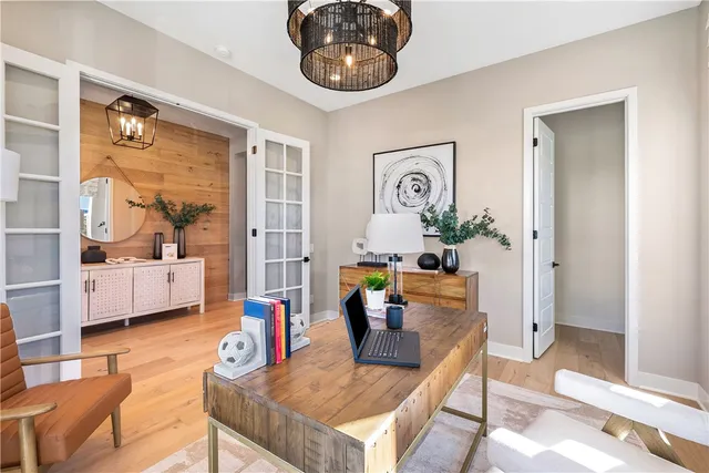 a kitchen with stainless steel appliances kitchen island granite countertop a dining table chairs and a refrigerator