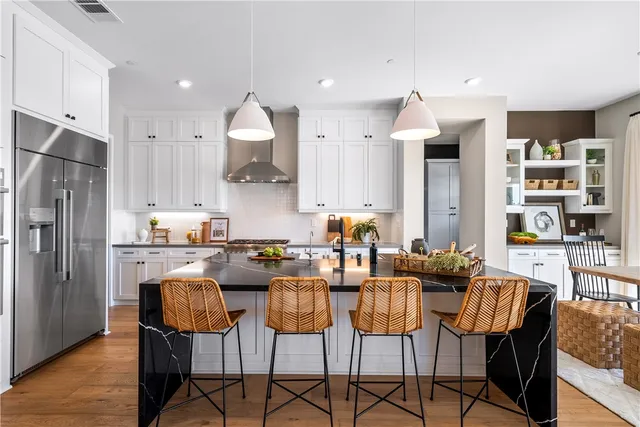 a living room with furniture a rug potted plant and a large window