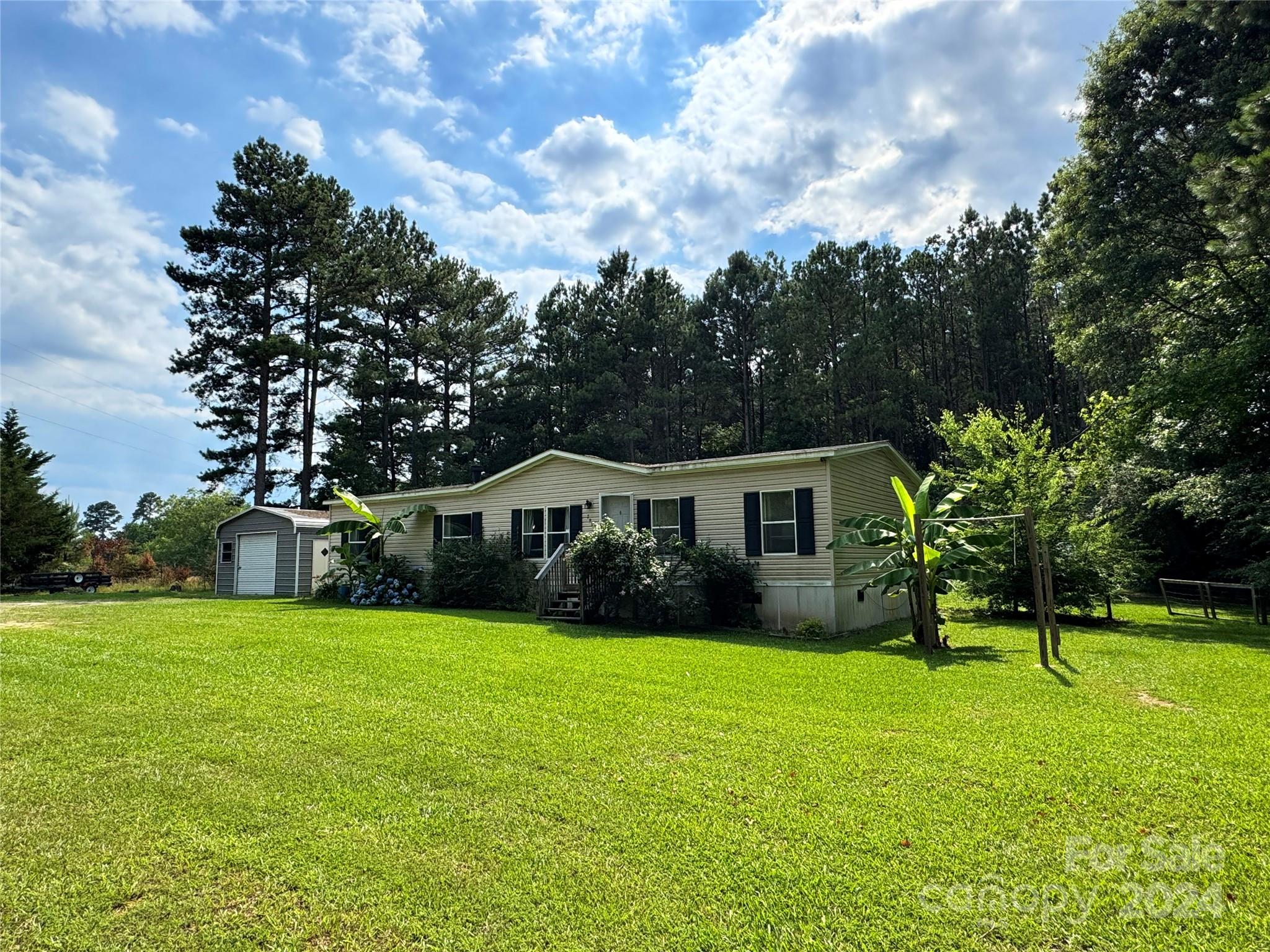 790 Langley Road Lancaster, SC 29720 - Photo 1 of 36 a view of a house with a yard and trees