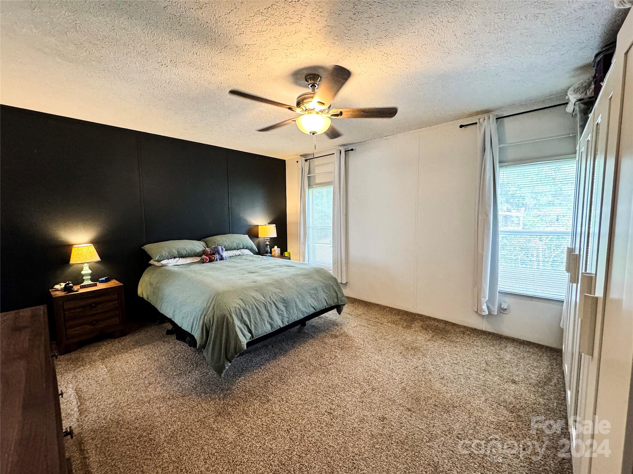 790 Langley Road Lancaster, SC 29720 - Photo 11 of 36 a bedroom with a bed and a chandelier