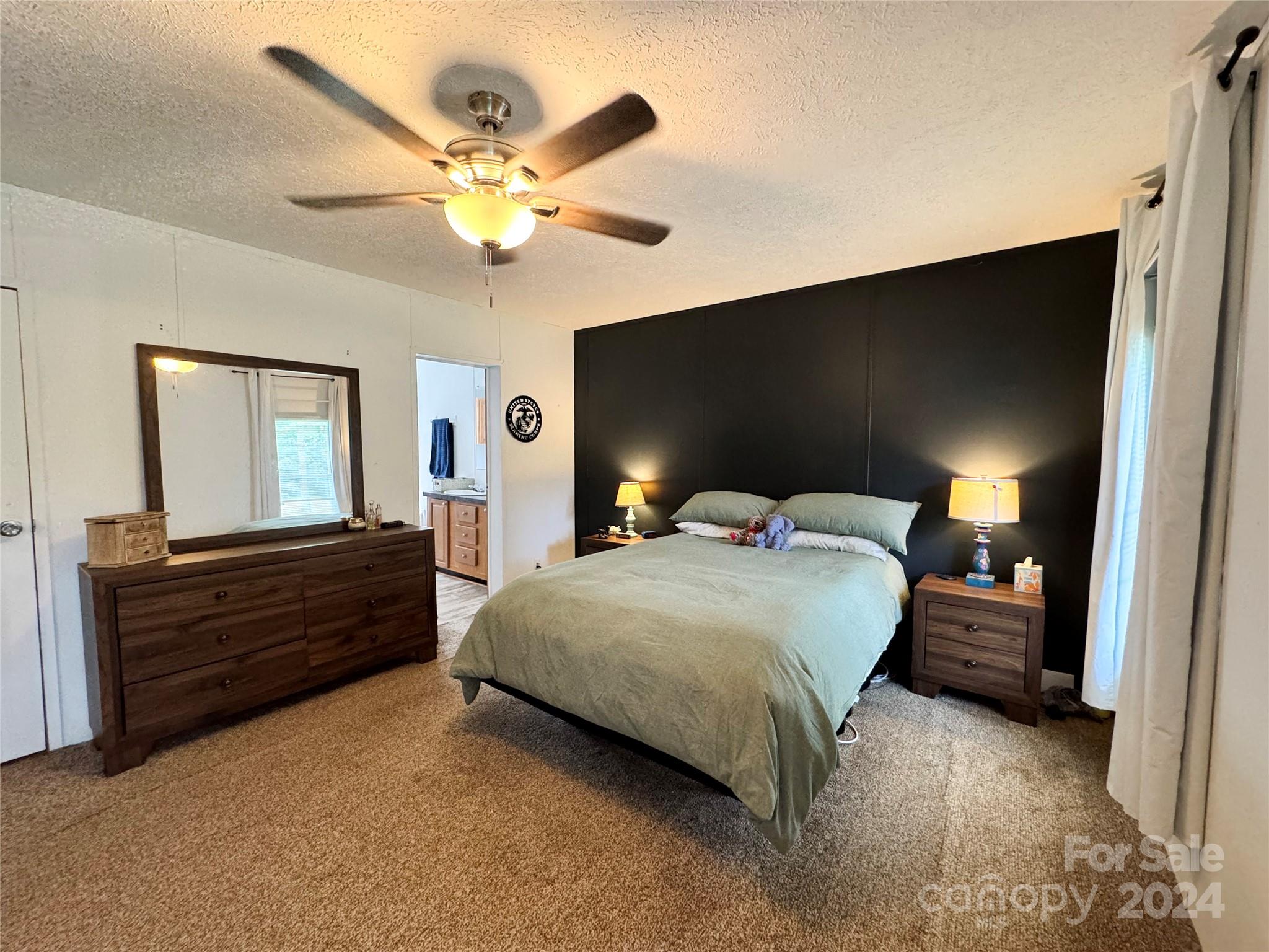 790 Langley Road Lancaster, SC 29720 - Photo 12 of 36 a bedroom with a bed and a chandelier