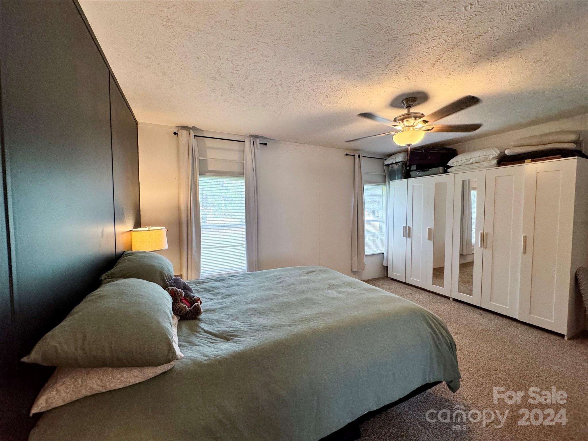790 Langley Road Lancaster, SC 29720 - Photo 13 of 36 a bedroom with a bed and a chandelier
