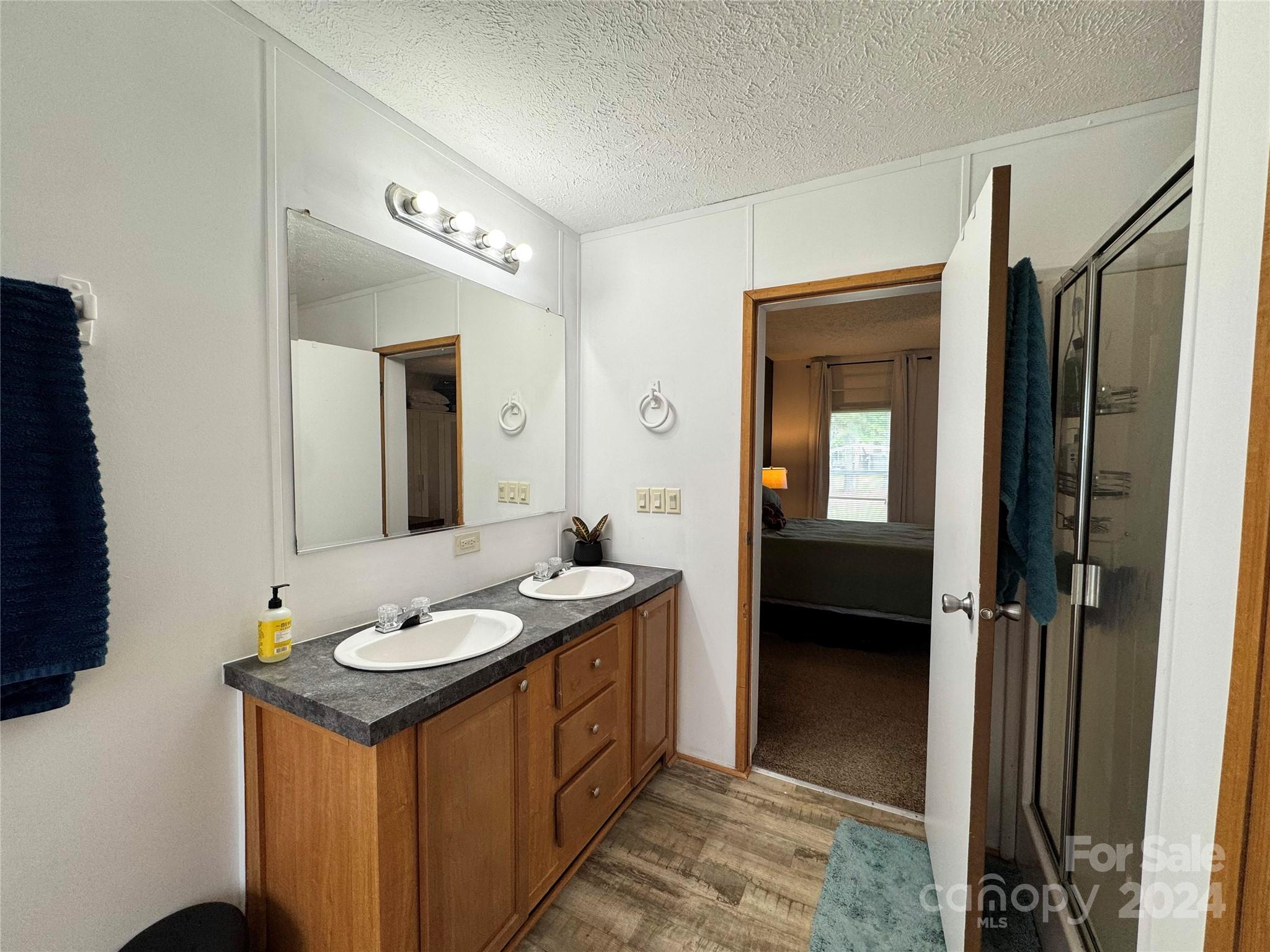 790 Langley Road Lancaster, SC 29720 - Photo 15 of 36 a en suite bathroom with a double vanity sink and a mirror