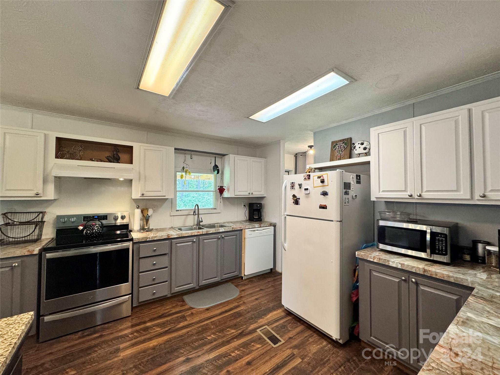 790 Langley Road Lancaster, SC 29720 - Photo 4 of 36 a kitchen with granite countertop a refrigerator stove top oven and sink