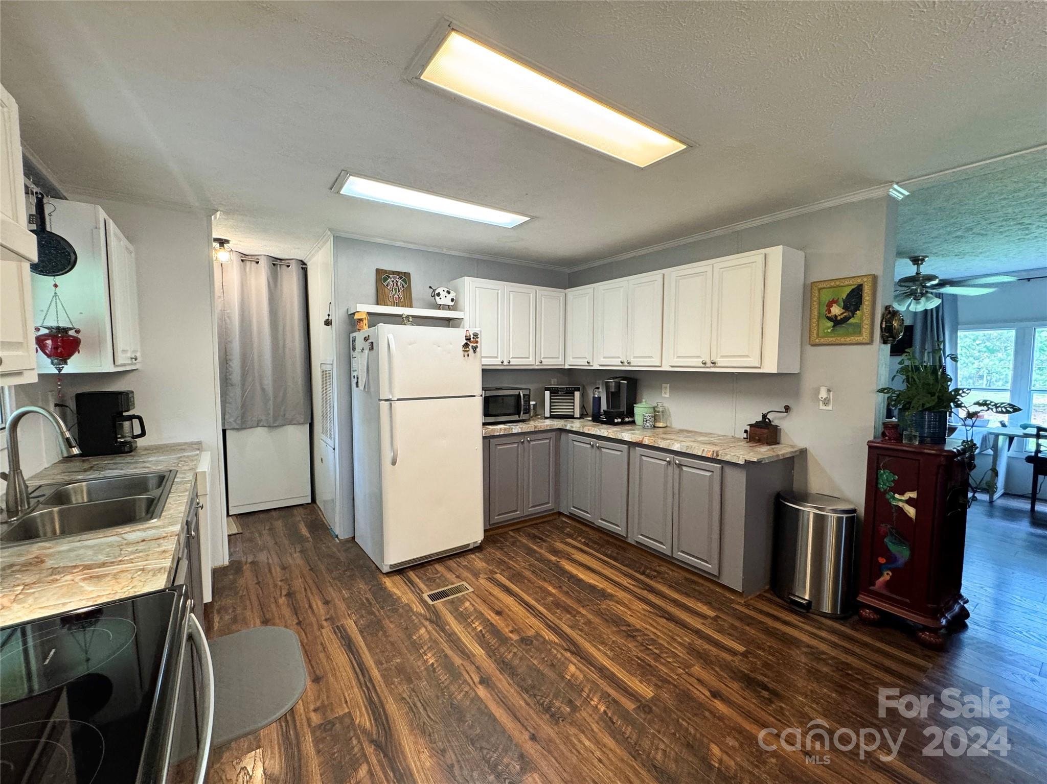 790 Langley Road Lancaster, SC 29720 - Photo 5 of 36 a kitchen with a refrigerator and a stove top oven