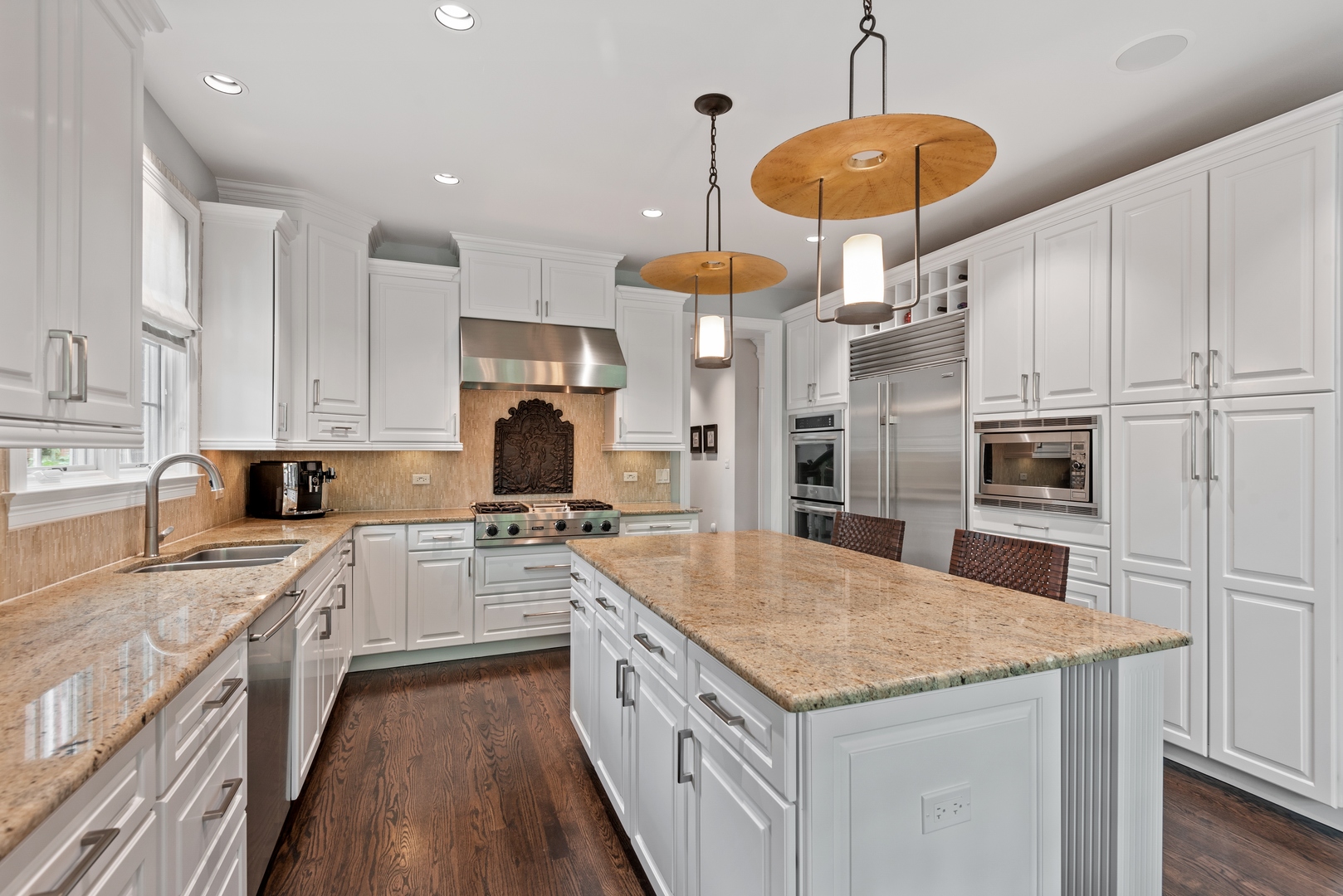 700 Harvard Street Wilmette, IL 60091 - Photo 13 of 50 a kitchen with stainless steel appliances granite countertop a sink a stove and a refrigerator