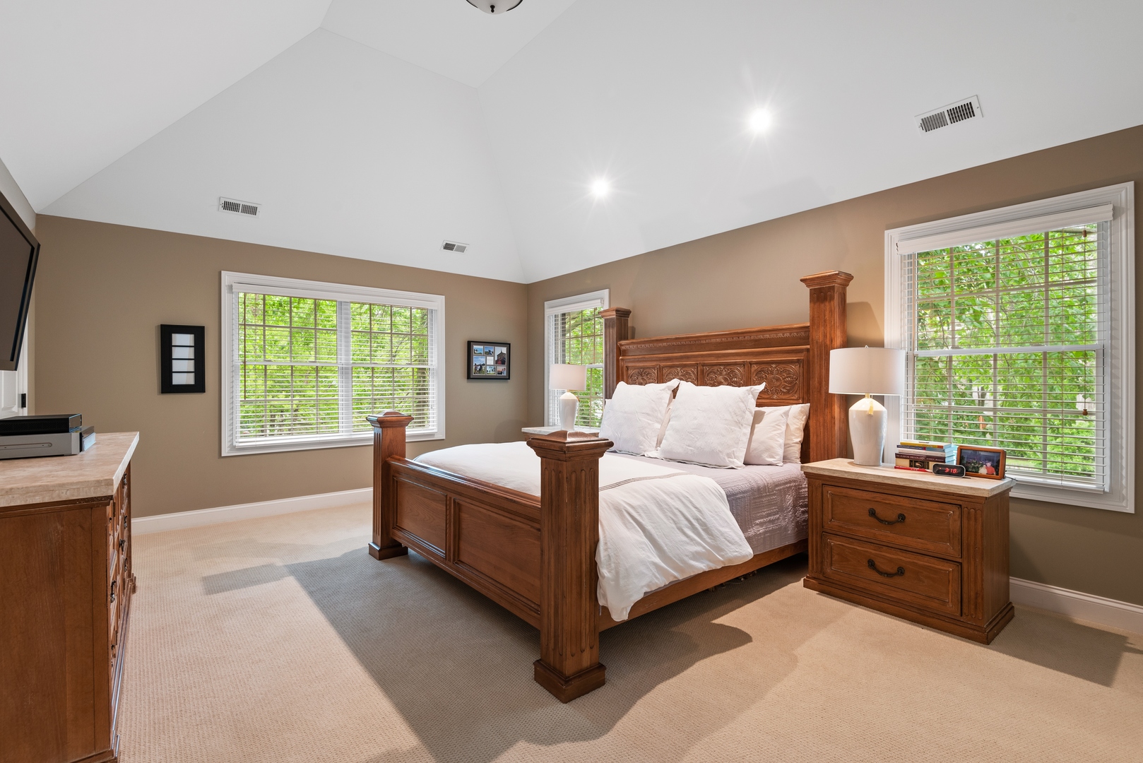 700 Harvard Street Wilmette, IL 60091 - Photo 23 of 50 a bedroom with a large bed and a flat tv screen on dresser