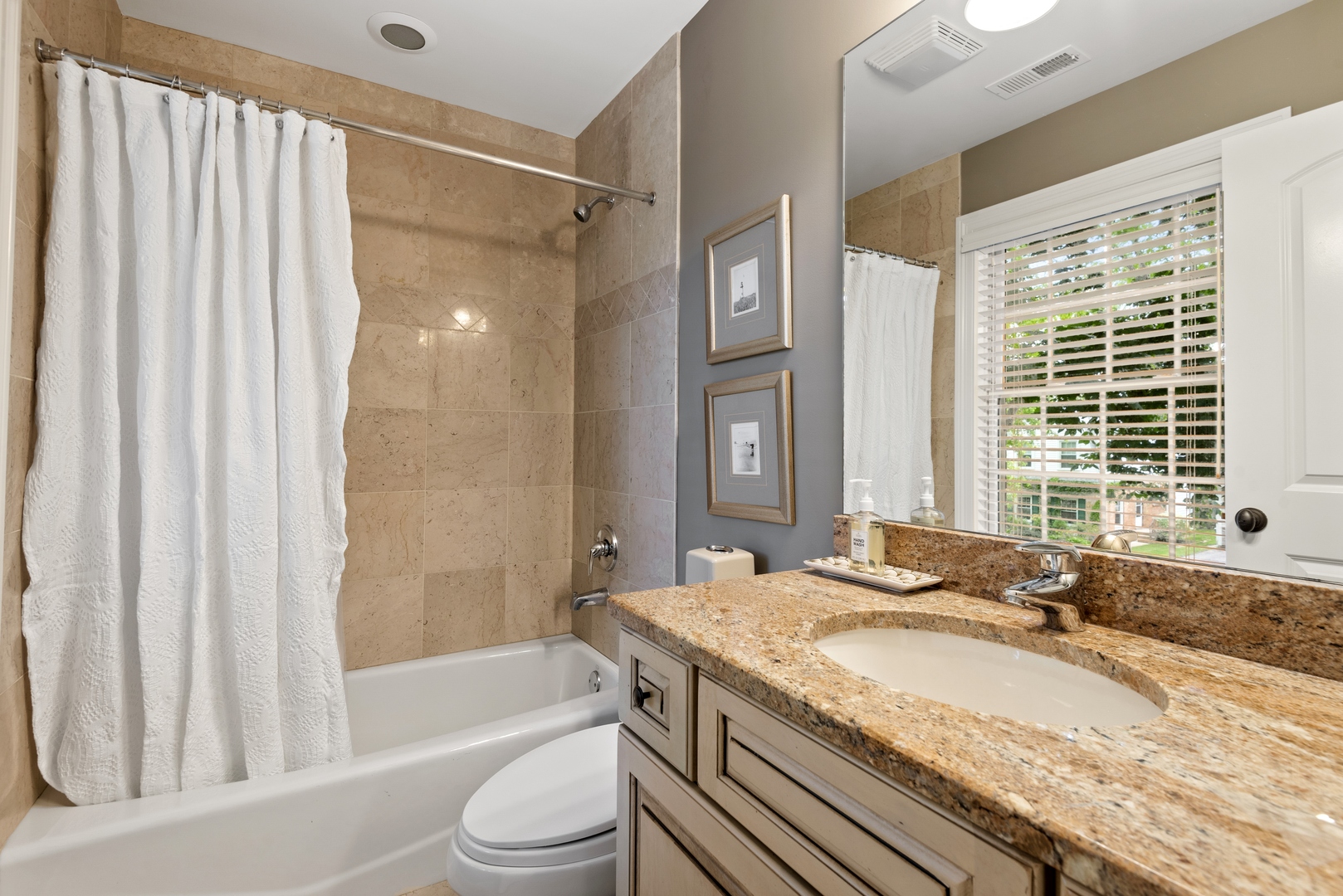 700 Harvard Street Wilmette, IL 60091 - Photo 28 of 50 a bathroom with a granite countertop tub sink and mirror