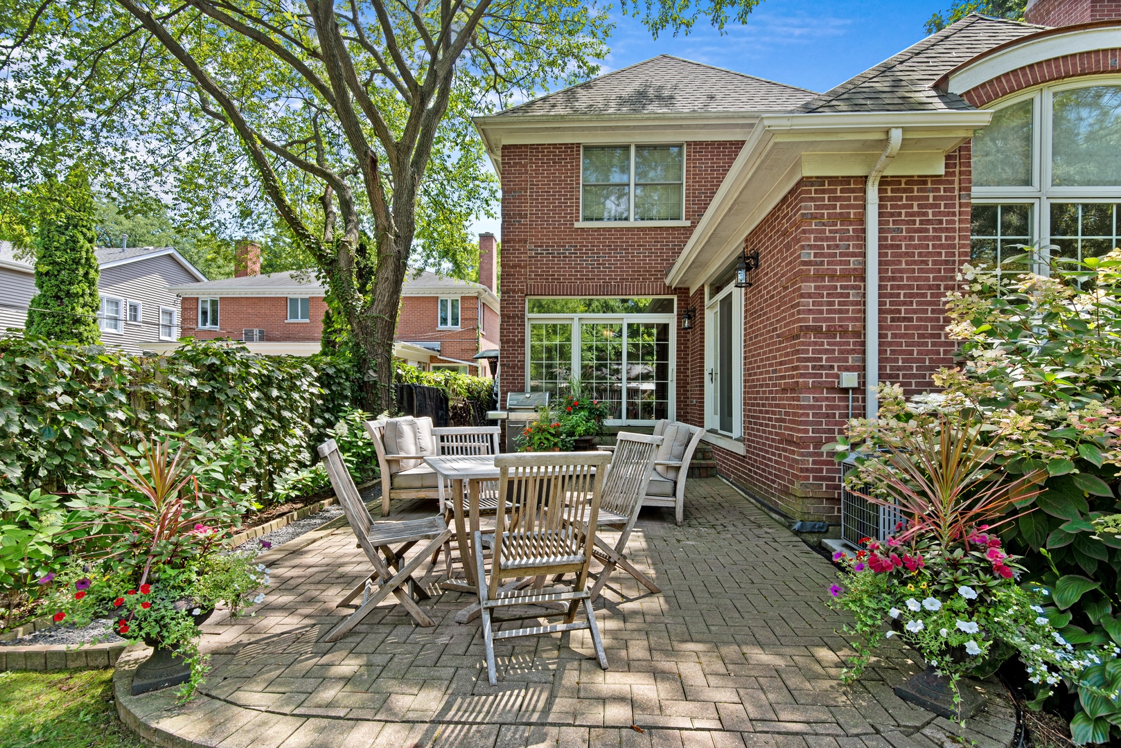 700 Harvard Street Wilmette, IL 60091 - Photo 42 of 50 a view of a patio with table and chairs and potted plants