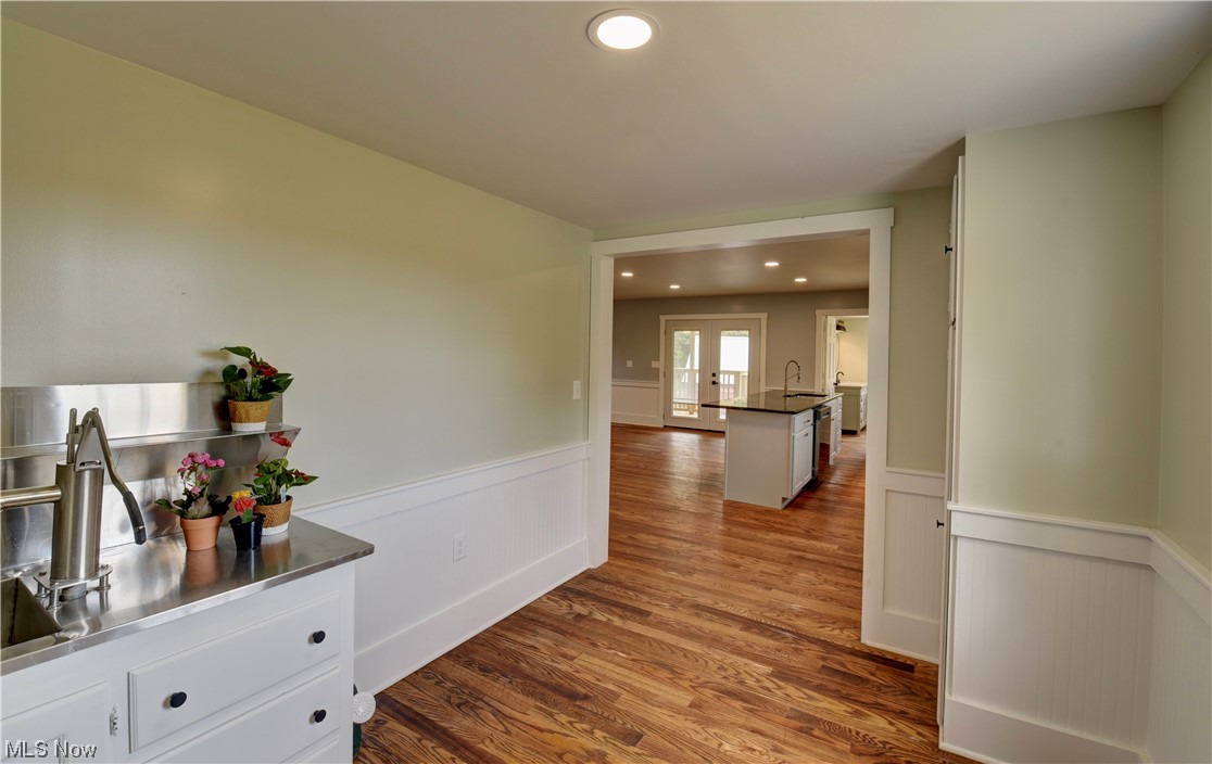 9734 Edwards Ridge Road Southeast Uhrichsville, OH 44683 - Photo 5 of 35 Hall with sink and dark hardwood floors