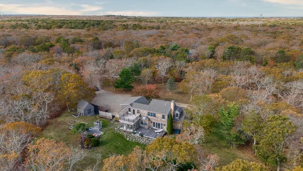 an aerial view of a house with a yard