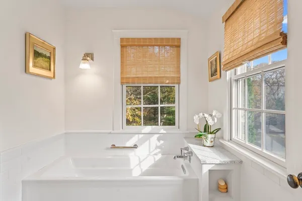 a bath tub sitting next to a window