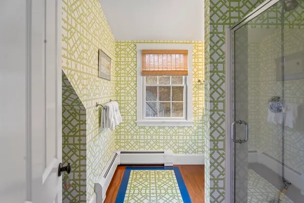 a bathroom with a window and a shower