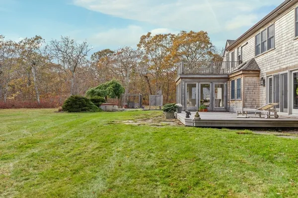 a view of a house with a backyard porch and sitting area