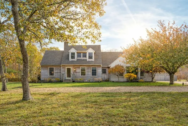 a front view of house with yard and green space