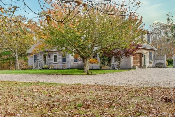 a big house with a big yard and large trees