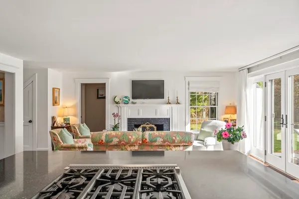 a living room with furniture fireplace and window
