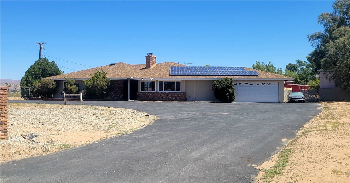 12430 Pawnee Road Apple Valley, CA 92308 - Photo 1 of 1 a front view of a house with a yard
