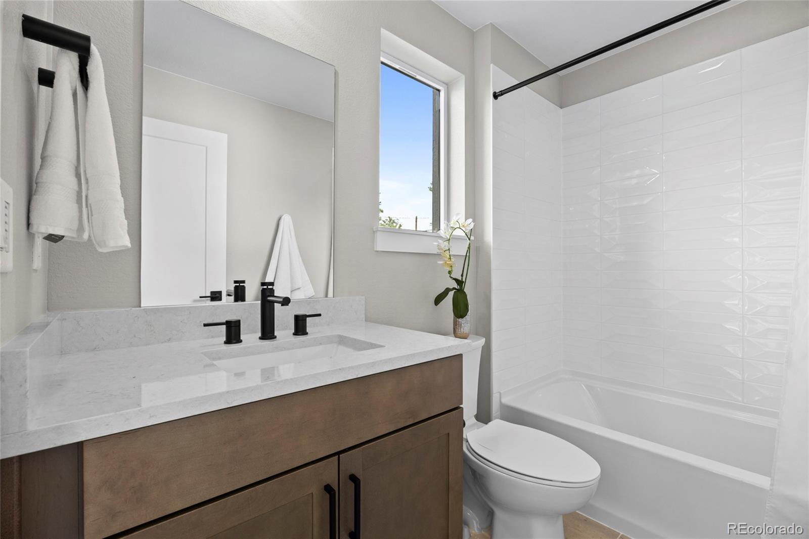 3420 Steele Street Denver, CO 80205 - Photo 11 of 50 a bathroom with a sink toilet vanity and tub