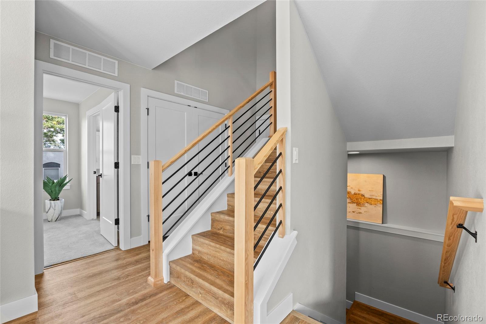3420 Steele Street Denver, CO 80205 - Photo 12 of 50 a view of entryway and hall with wooden floor