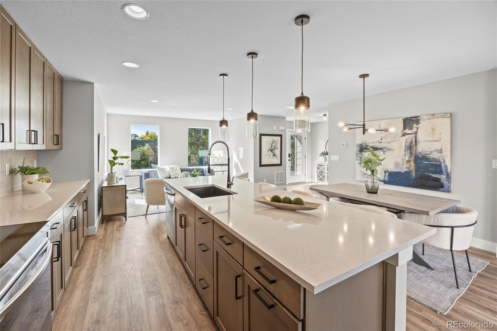 3420 Steele Street Denver, CO 80205 - Photo 15 of 50 a kitchen with stainless steel appliances granite countertop a sink a stove and a wooden floors