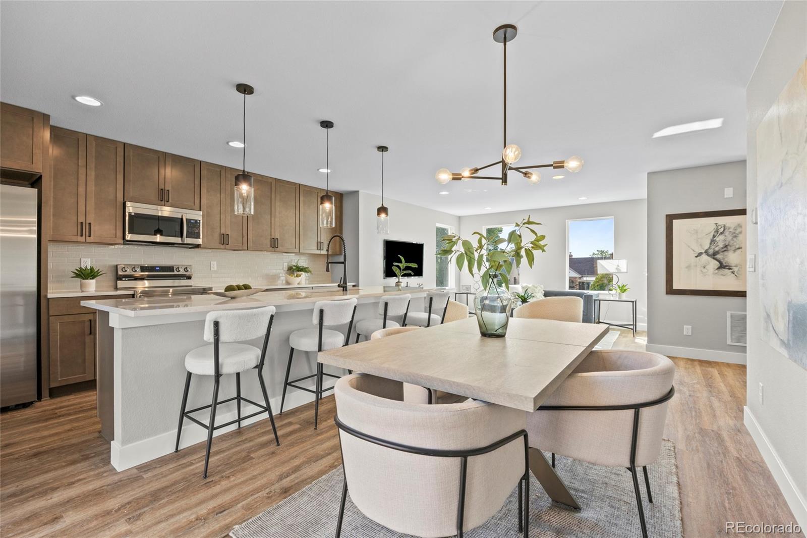 3420 Steele Street Denver, CO 80205 - Photo 17 of 50 a view of kitchen with refrigerator a stove and wooden floor
