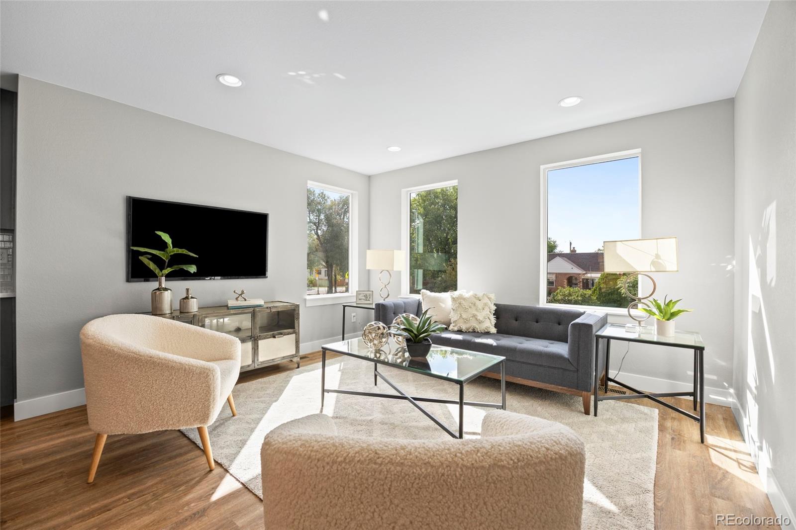 3420 Steele Street Denver, CO 80205 - Photo 20 of 50 a living room with furniture and a flat screen tv