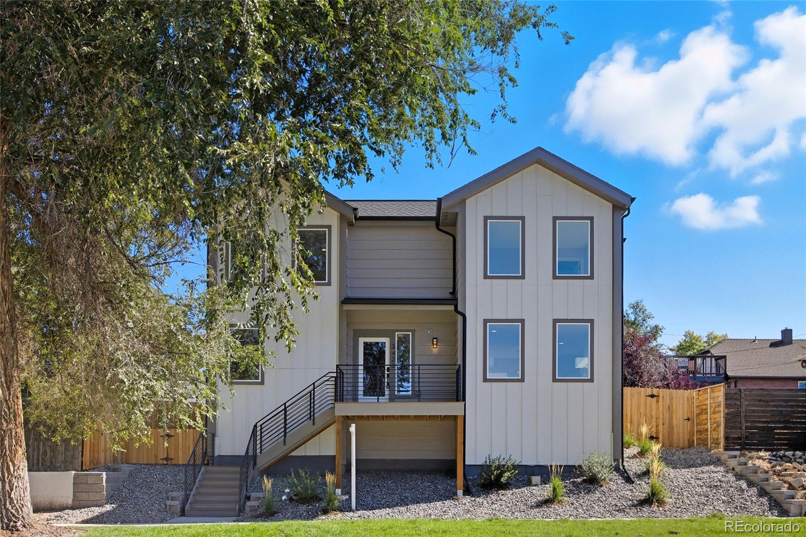 3420 Steele Street Denver, CO 80205 - Photo 2 of 50 a front view of a house with garden