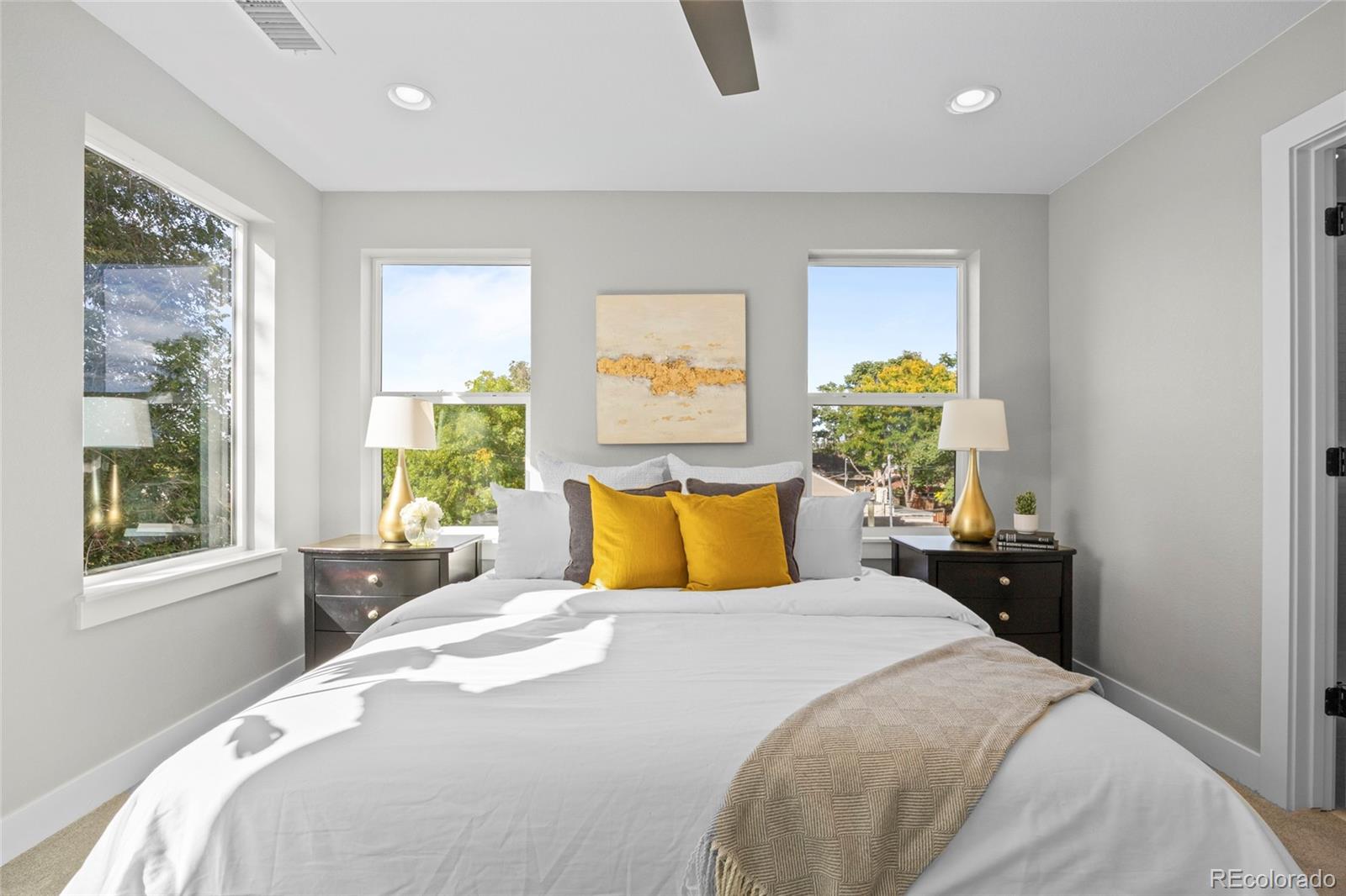 3420 Steele Street Denver, CO 80205 - Photo 23 of 50 a bedroom with a bed and wooden floor