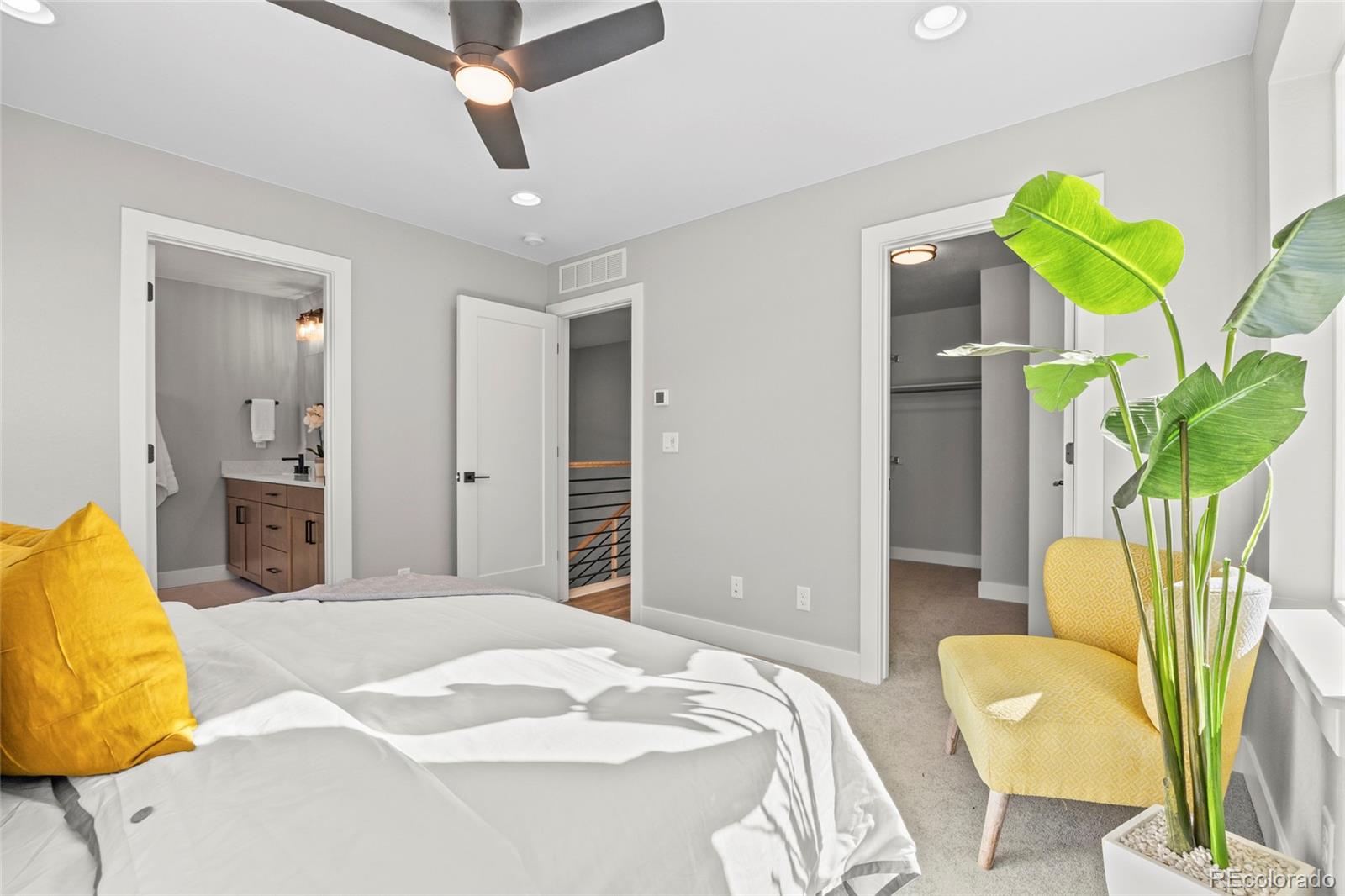 3420 Steele Street Denver, CO 80205 - Photo 24 of 50 a bedroom with a bed and ceiling fan