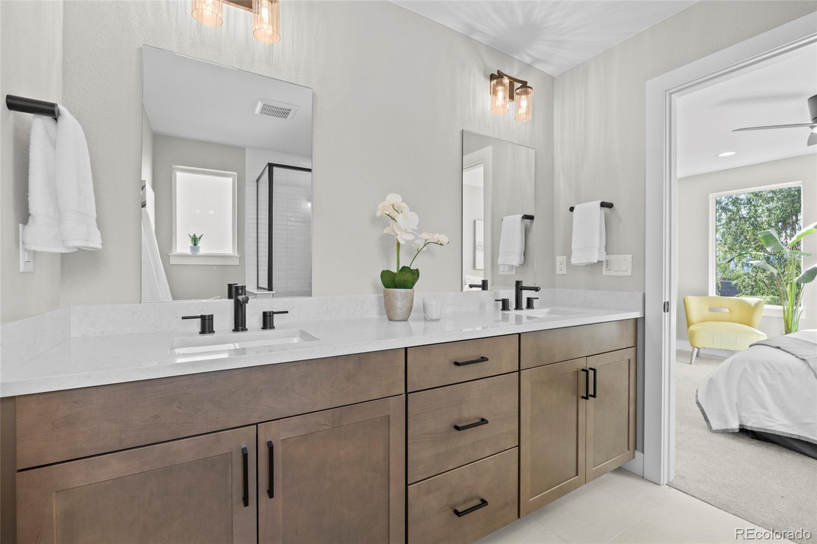 3420 Steele Street Denver, CO 80205 - Photo 25 of 50 a en suite bathroom with double sink and a mirror