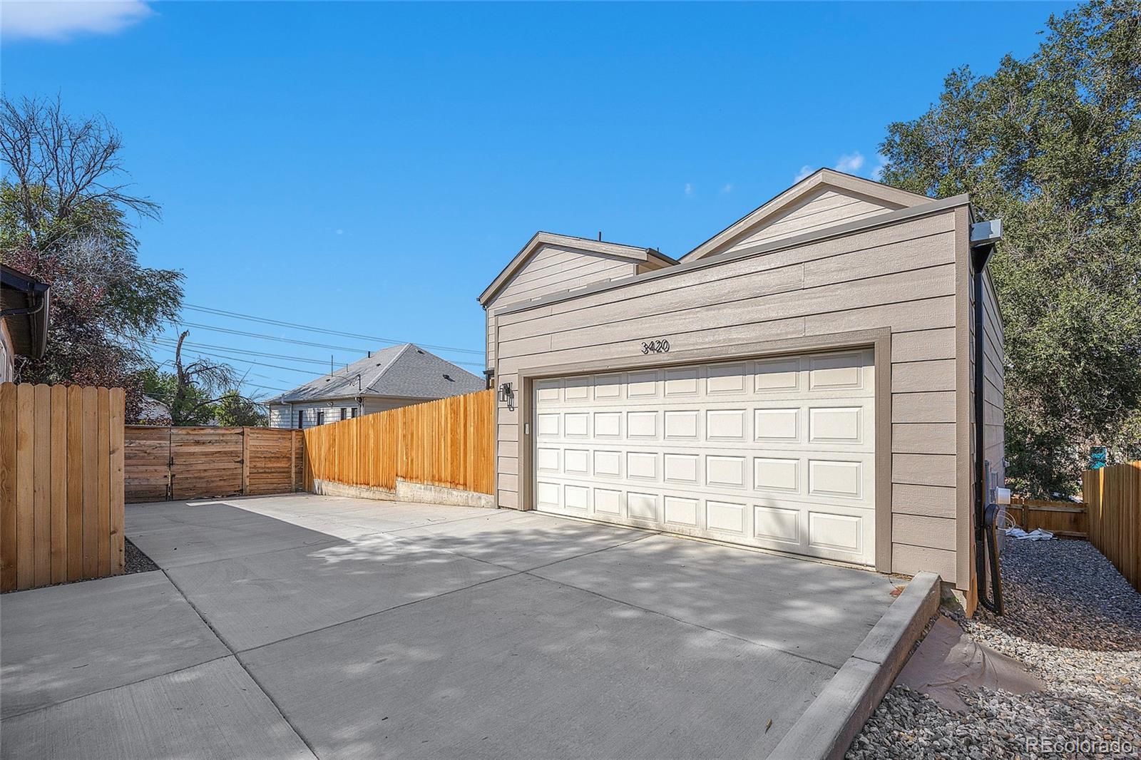 3420 Steele Street Denver, CO 80205 - Photo 38 of 50 a view of backyard with a small cabin and wooden fence